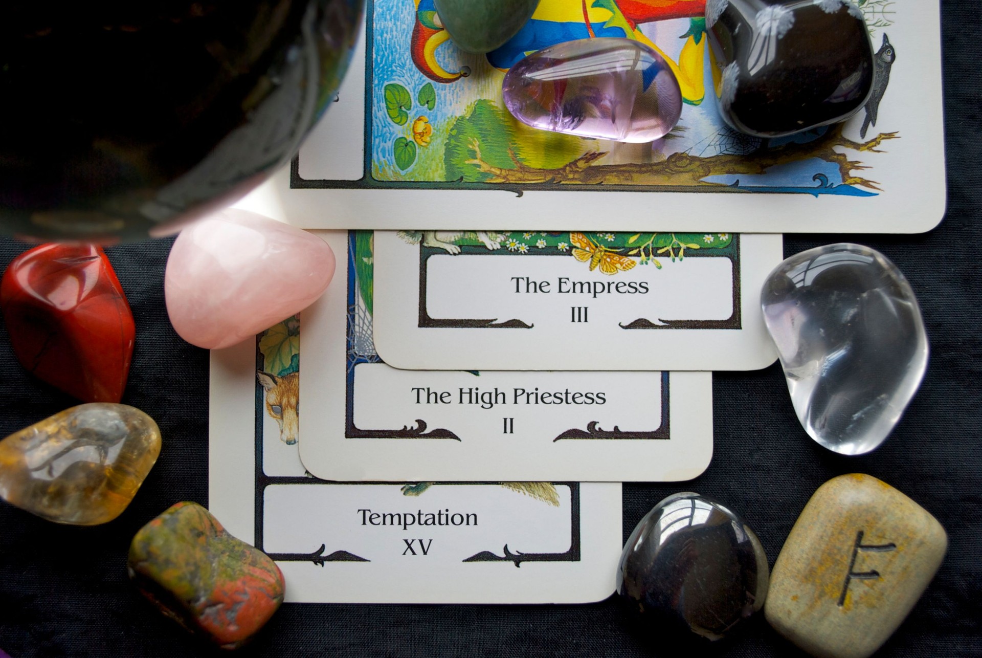 Tarot card reading with gems scattered on the table